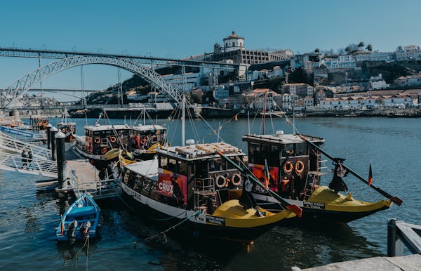 free-photo-of-view-of-boats-on-the-river-douro-and-dom-luis-i-bridge-in-the-background-porto-portugal